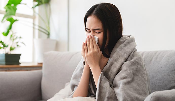 A girl is suffering from allergies because of the humidity.