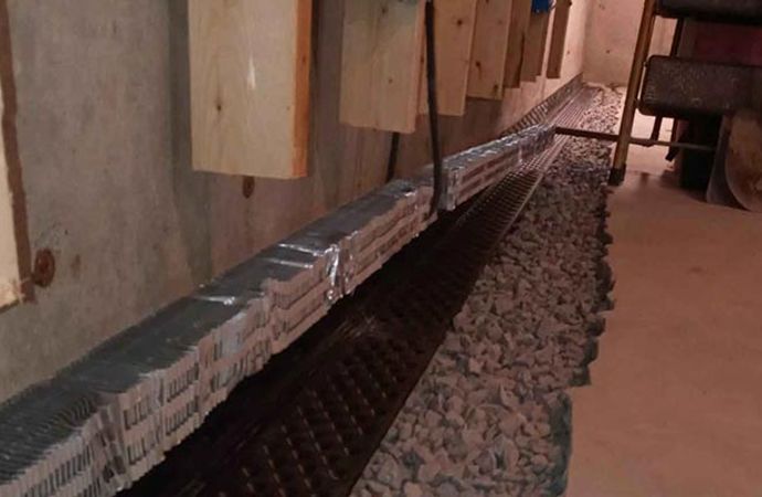 Interior drainage system installed along basement wall