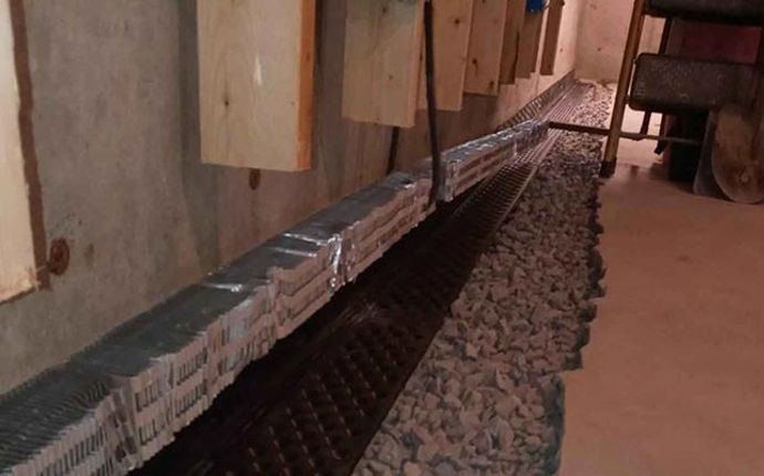 Basement interior drainage system installed along the foundation wall