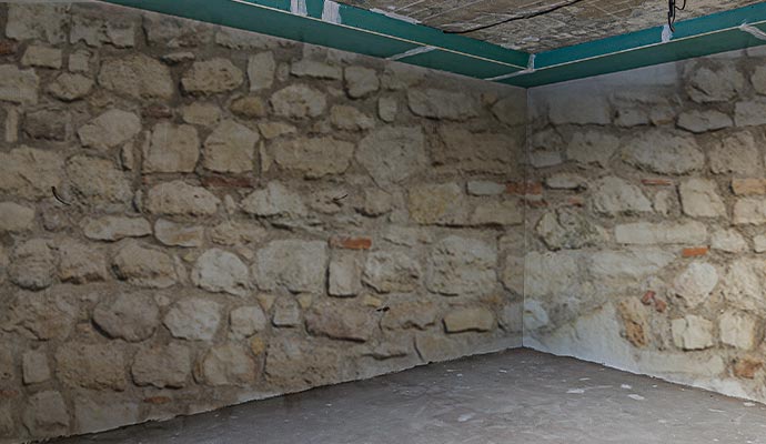 Uneven Stone Basement Wall Finishing in Concord, NH