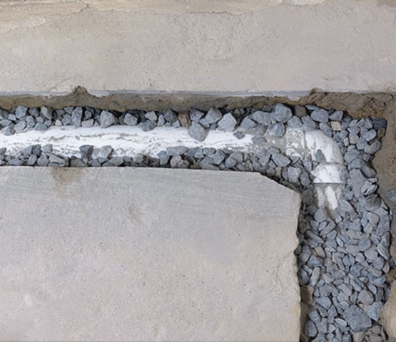 A basement french-drain installation service in progress