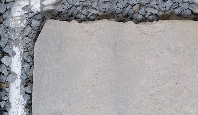 Interior unfinished drain with drainage rocks