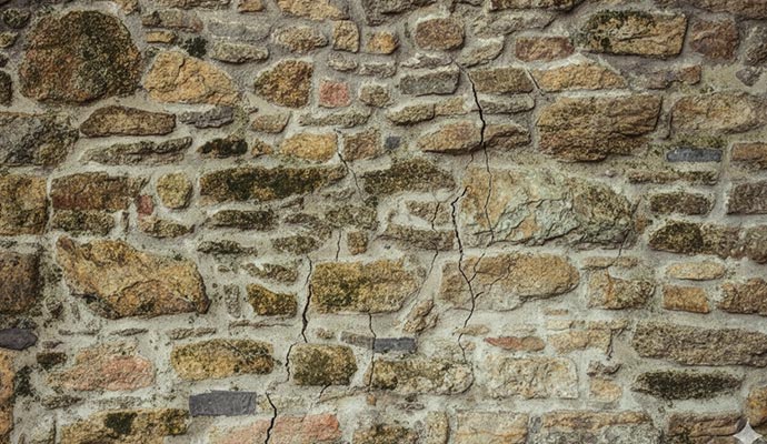 Stone basement wall with a large vertical crack