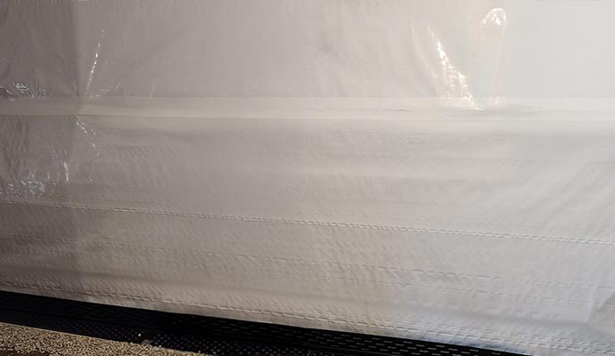 White vapor barrier liner installed on basement wall