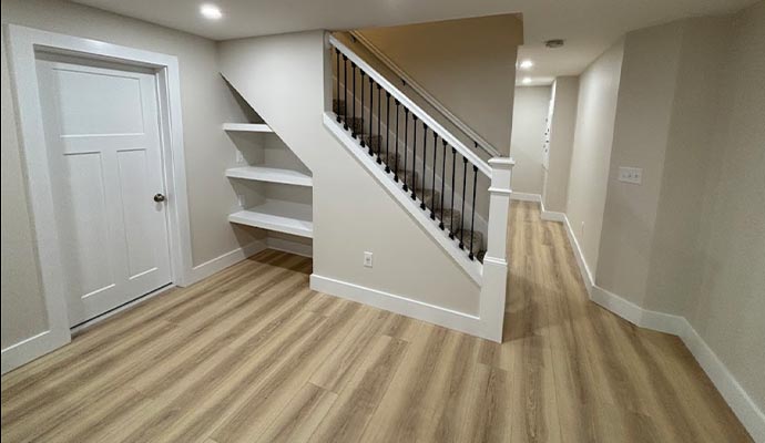 A basement with clean wood-look laminate flooring