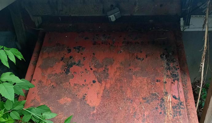 rusted metal crawl space access door