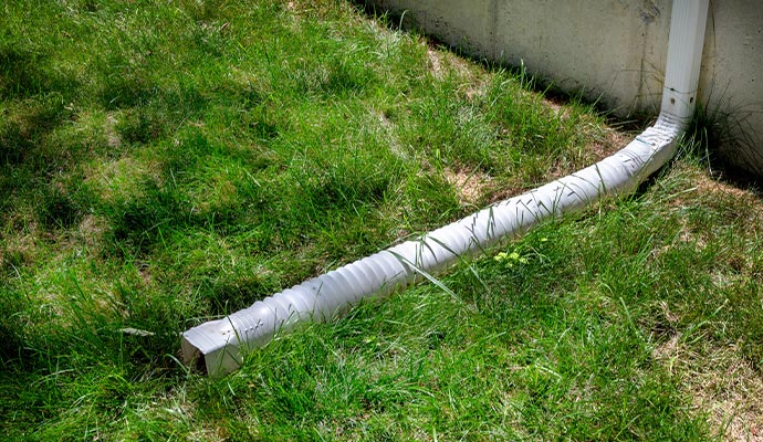 Downspout extension installed to direct rainwater away from the foundation.