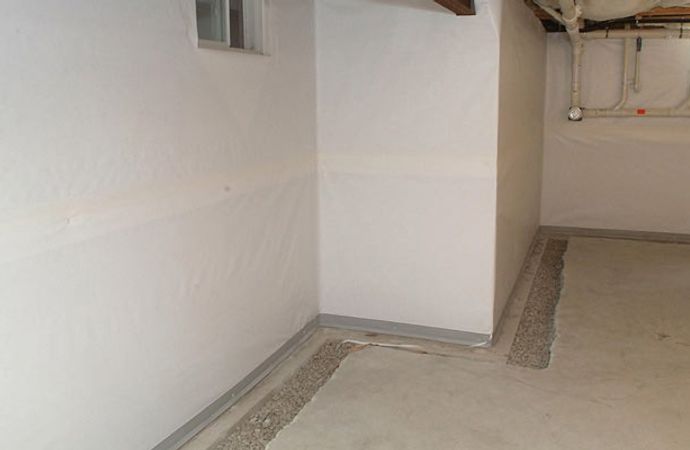 Professional interior drainage installation to prevent basement flooding