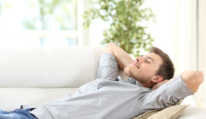 man relaxing on sofa