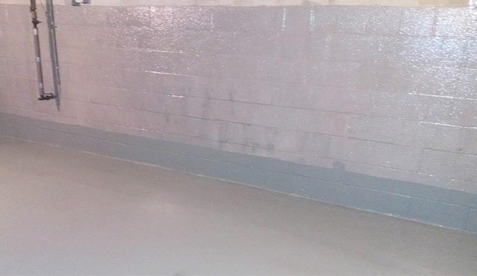 Sealed basement wall with coating