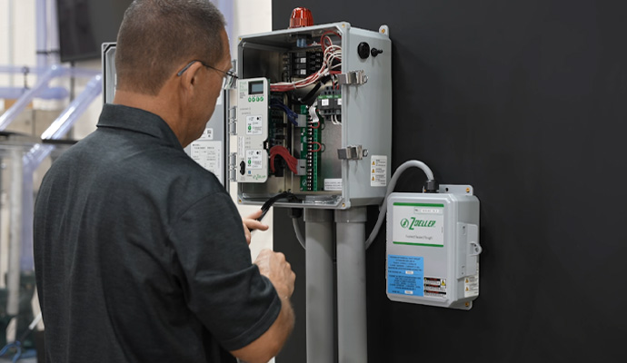 Technician checking Zoeller sump pump control system